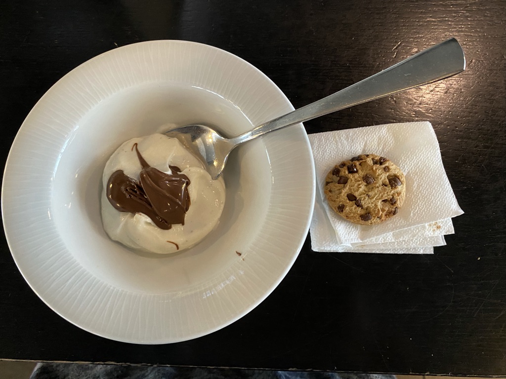 a spoon in a bowl with a cookie