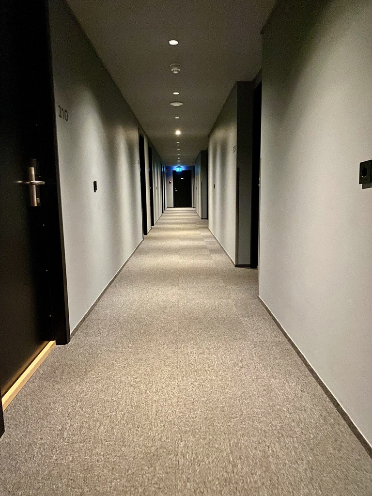 a hallway with doors and lights