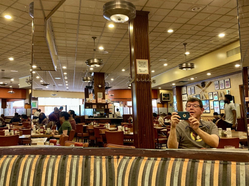 a man taking a selfie in a restaurant