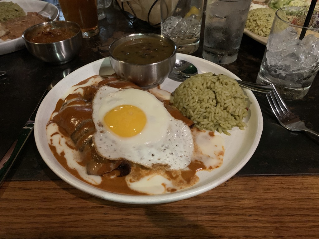 a plate of food with a fried egg and rice