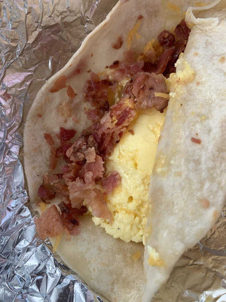 a breakfast taco with eggs and bacon