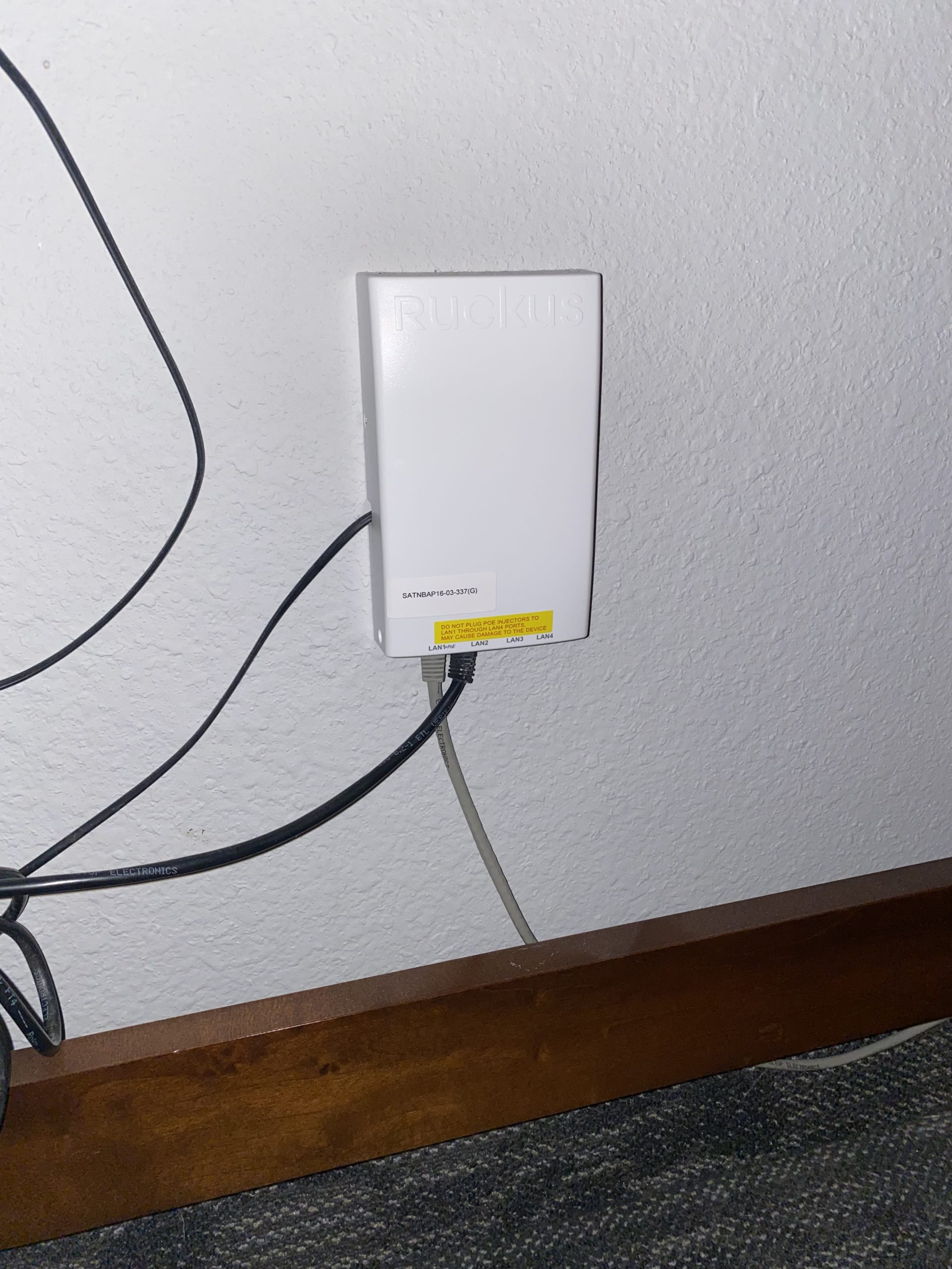 a white box with wires on a wall