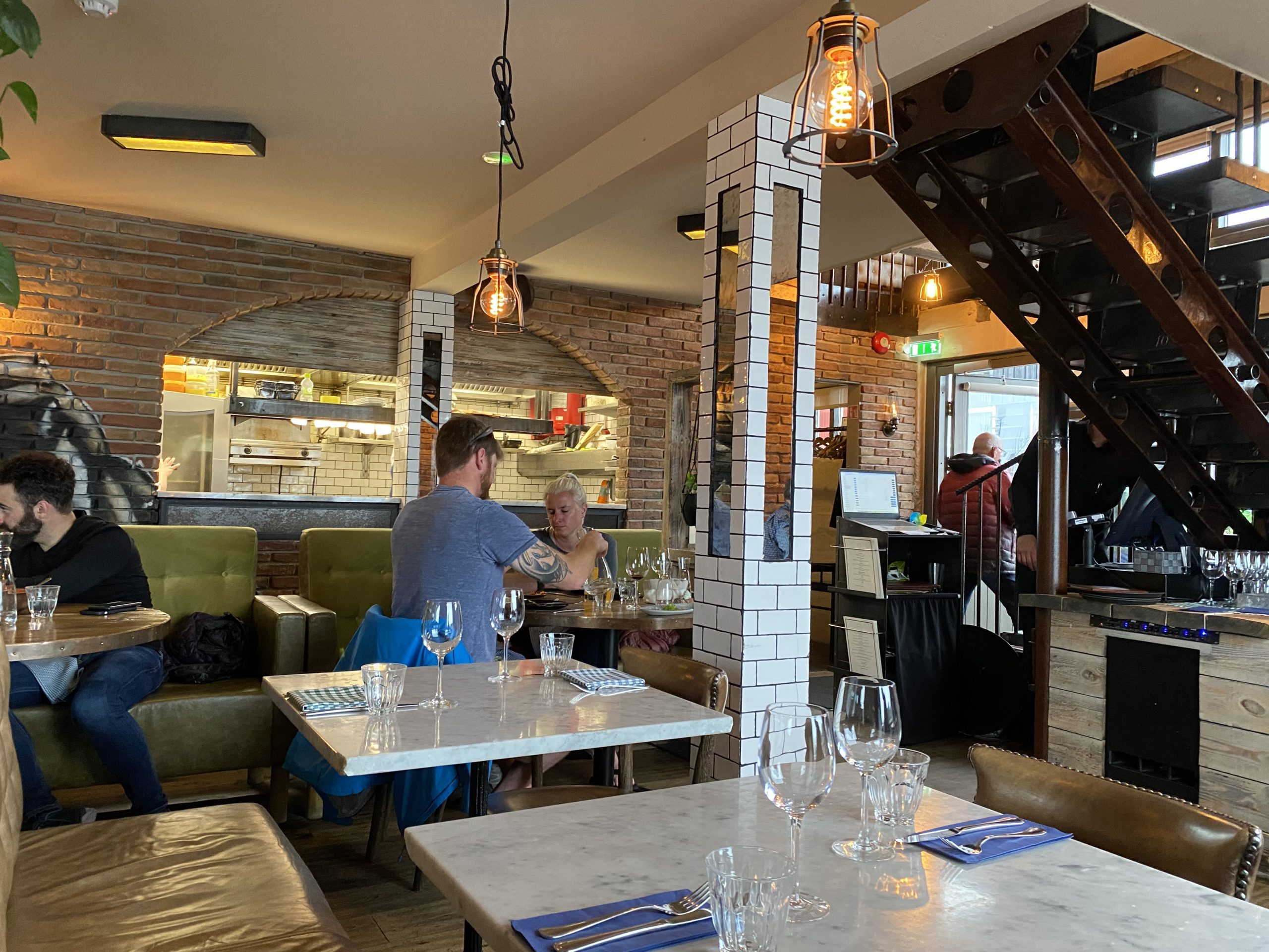 a group of people sitting at tables in a restaurant