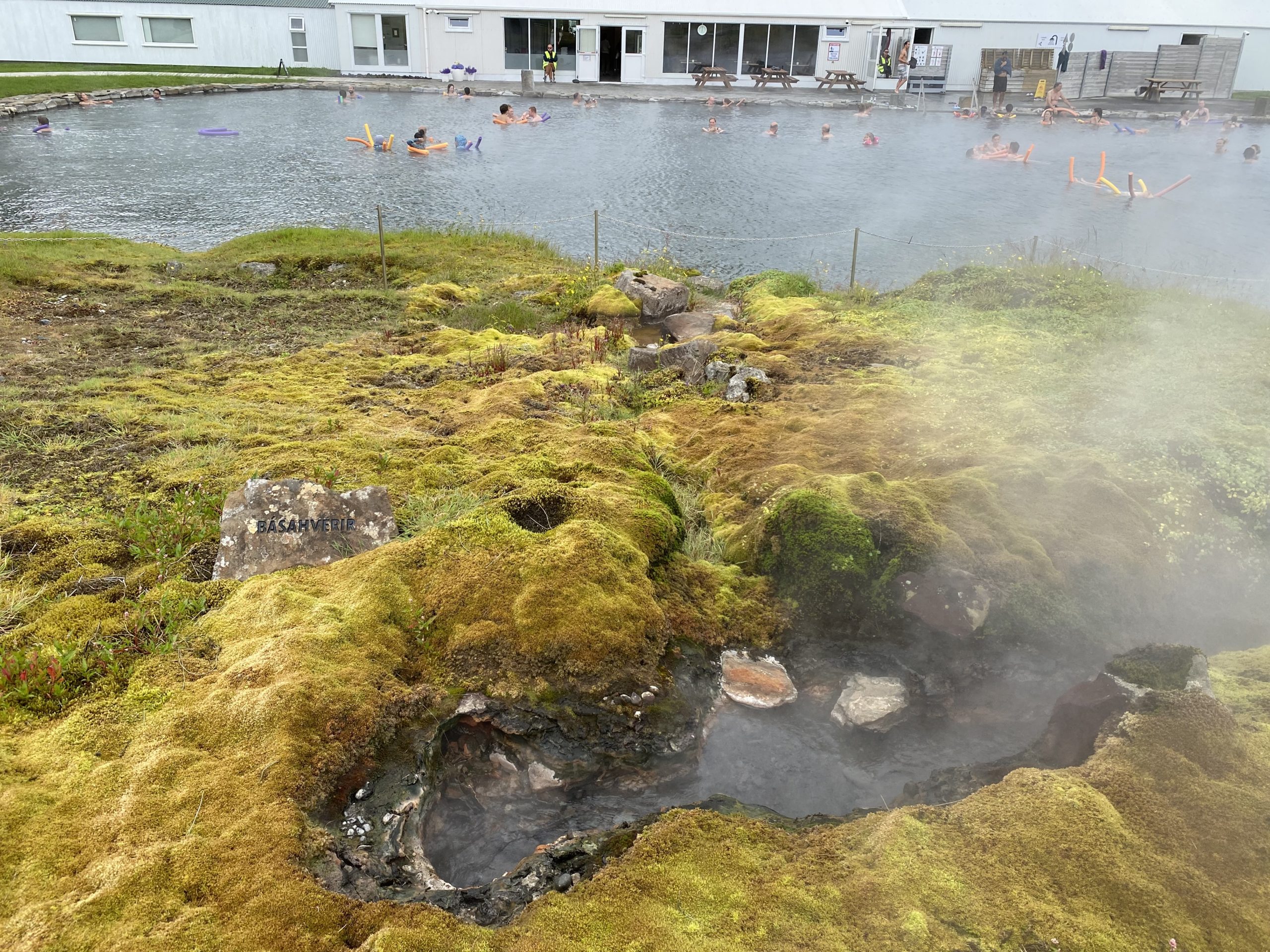 a pool with hot springs and people swimming in it