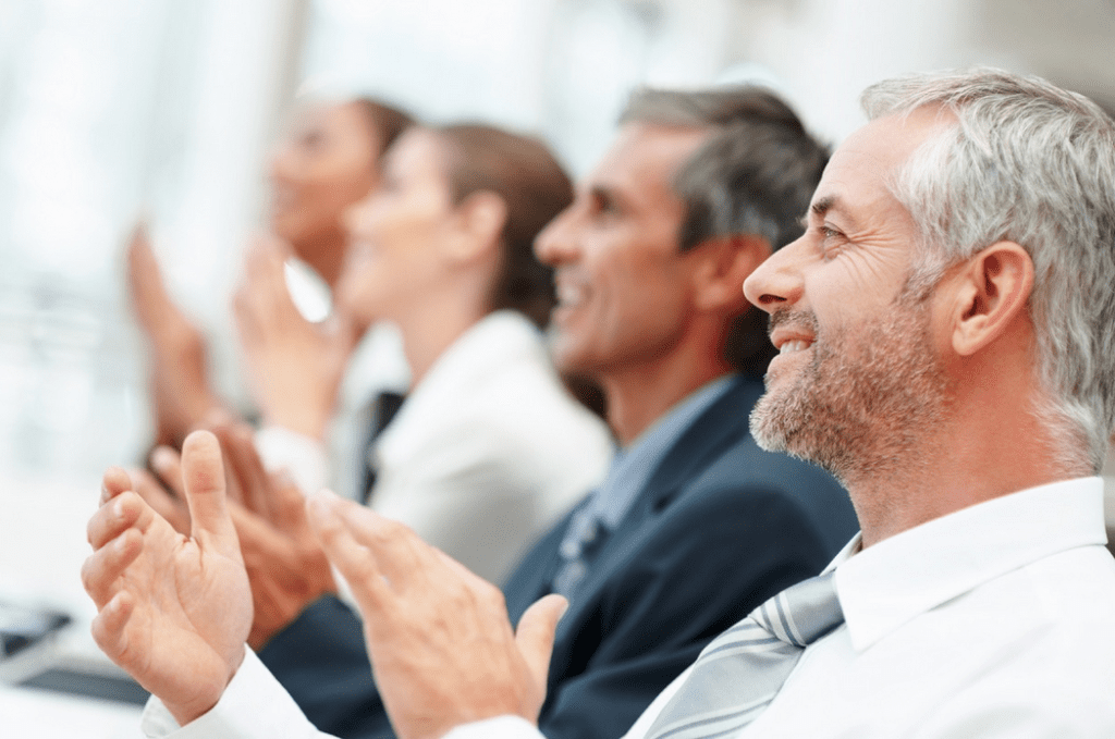 a group of people clapping