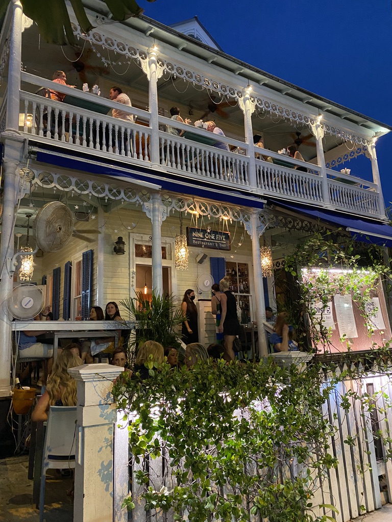 a building with people sitting at tables and a balcony