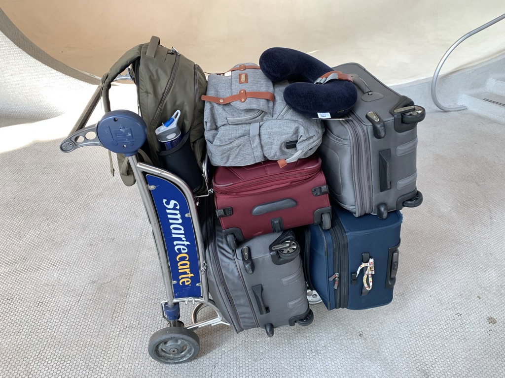 a luggage cart full of luggage