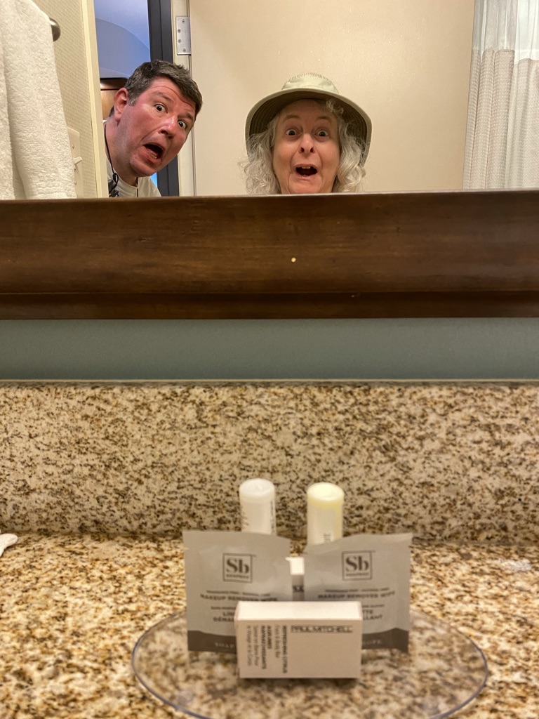 a man and woman in a bathroom mirror