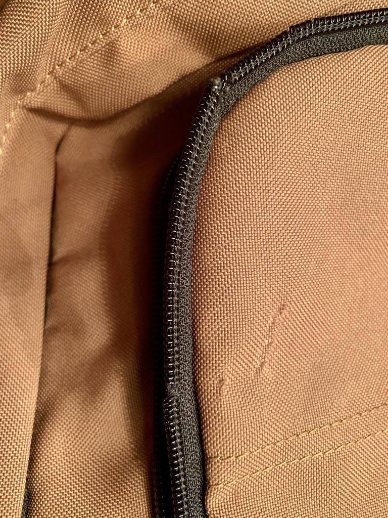 a zipper on a brown bag