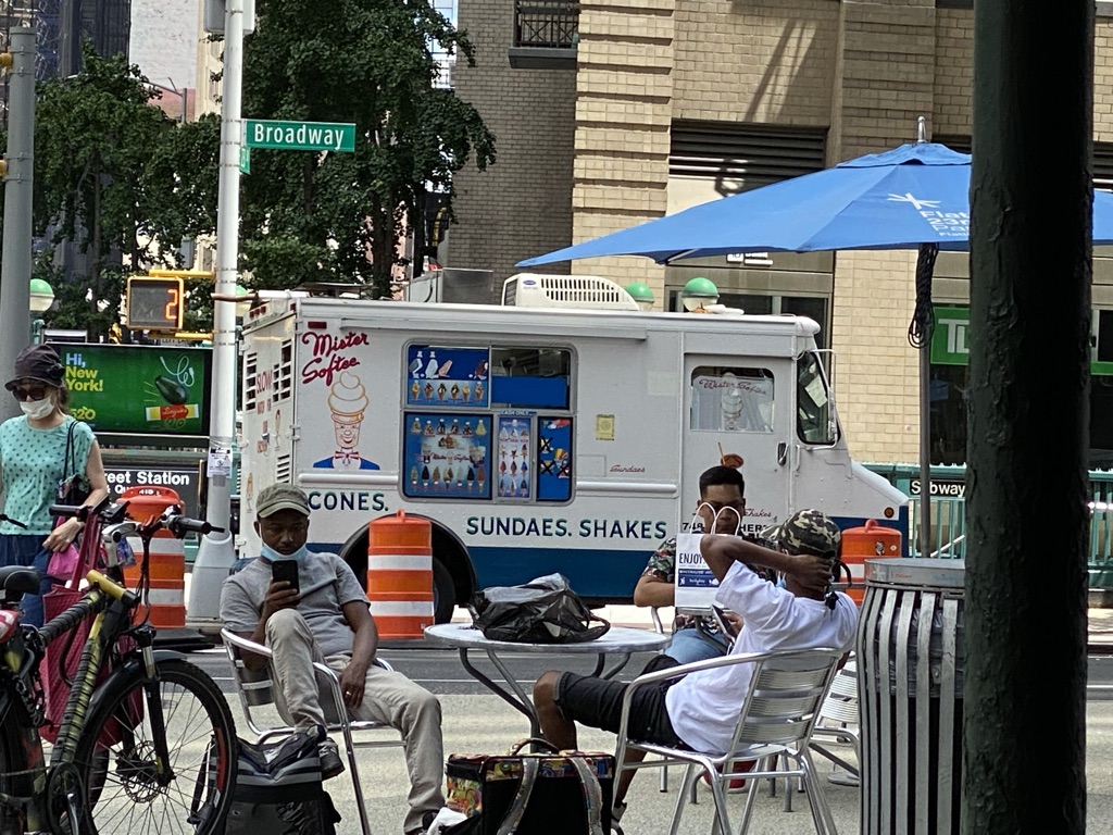 a group of people sitting at a table outside