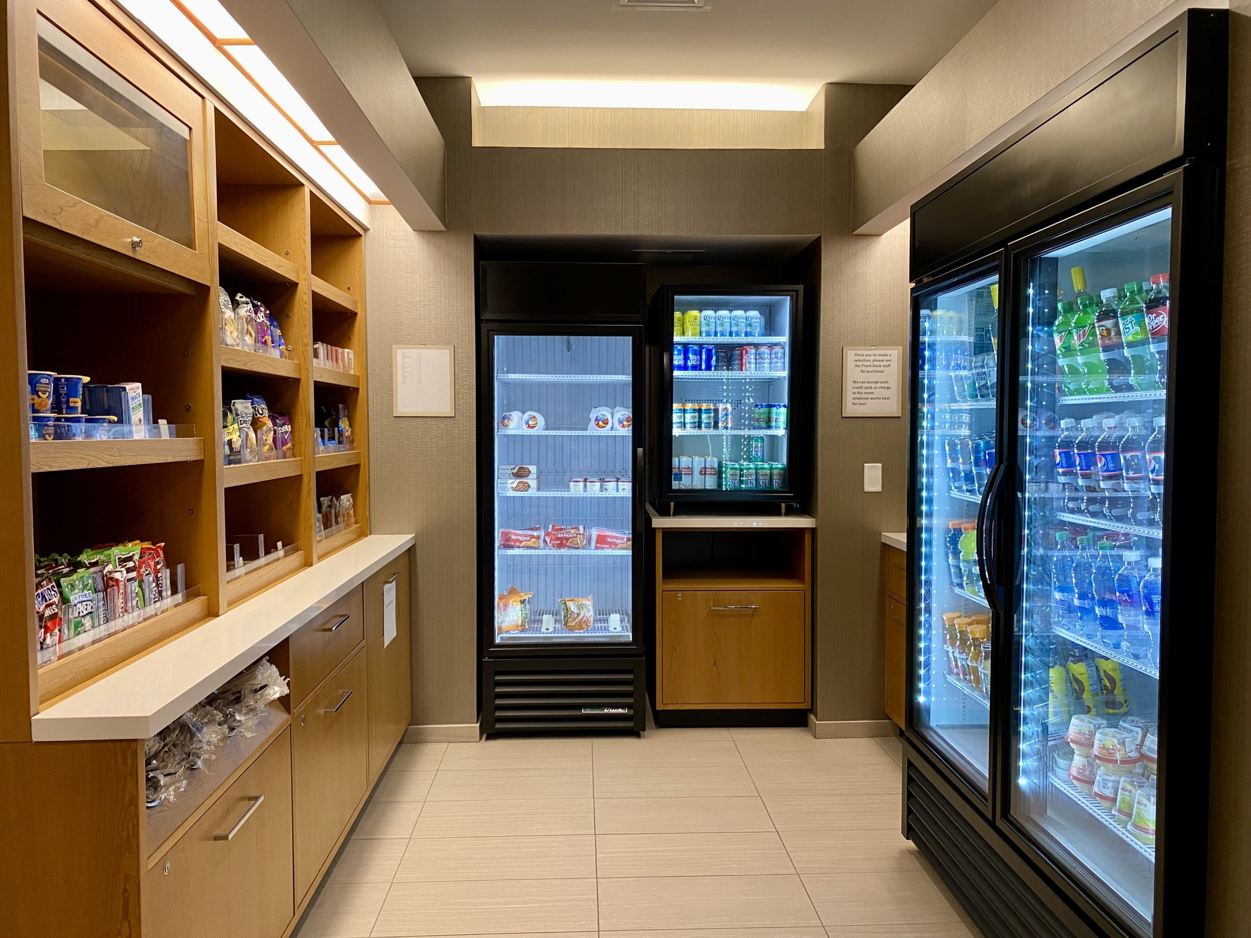 a room with shelves of beverages and refrigerators