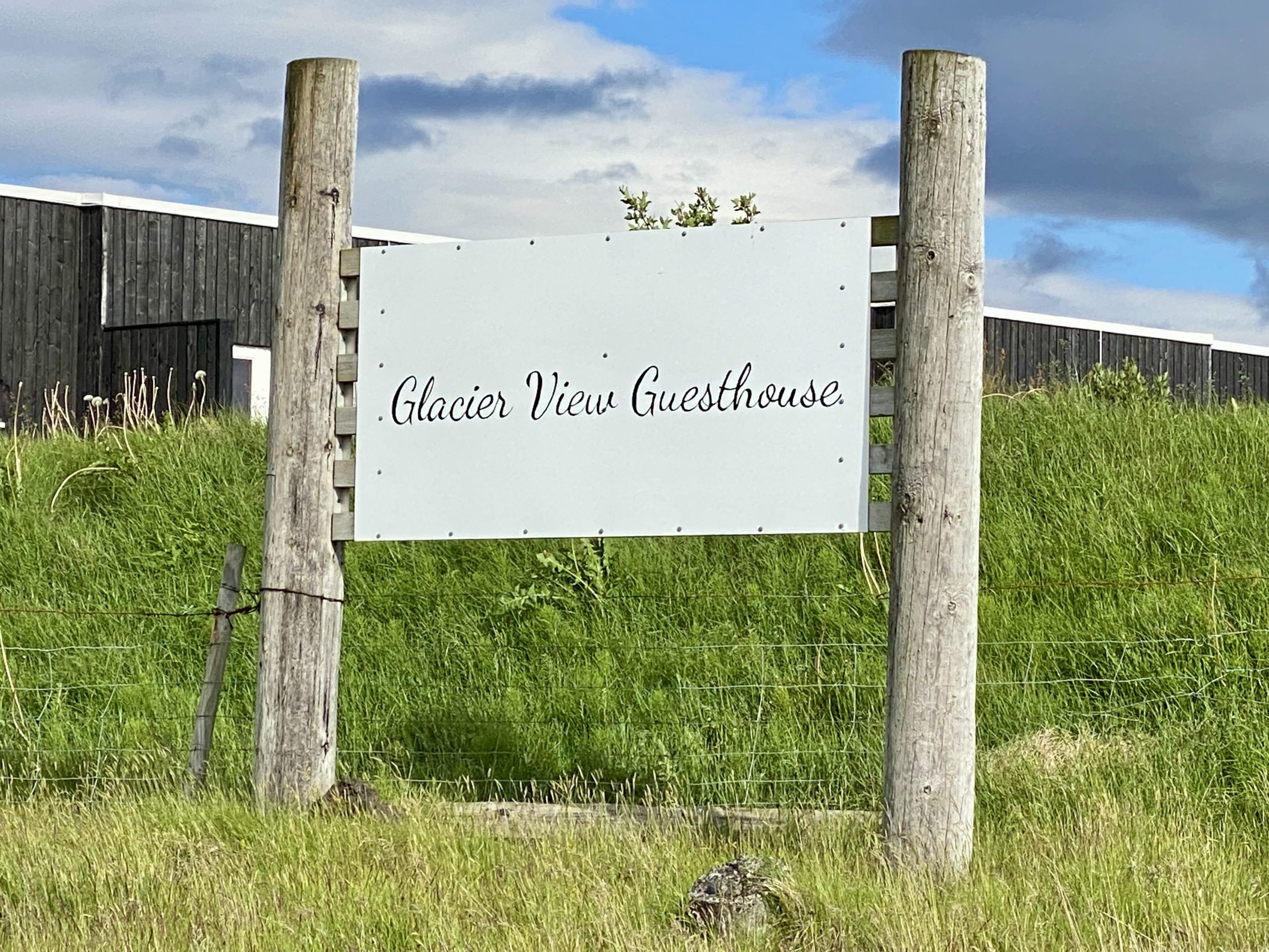 a sign in a grassy field