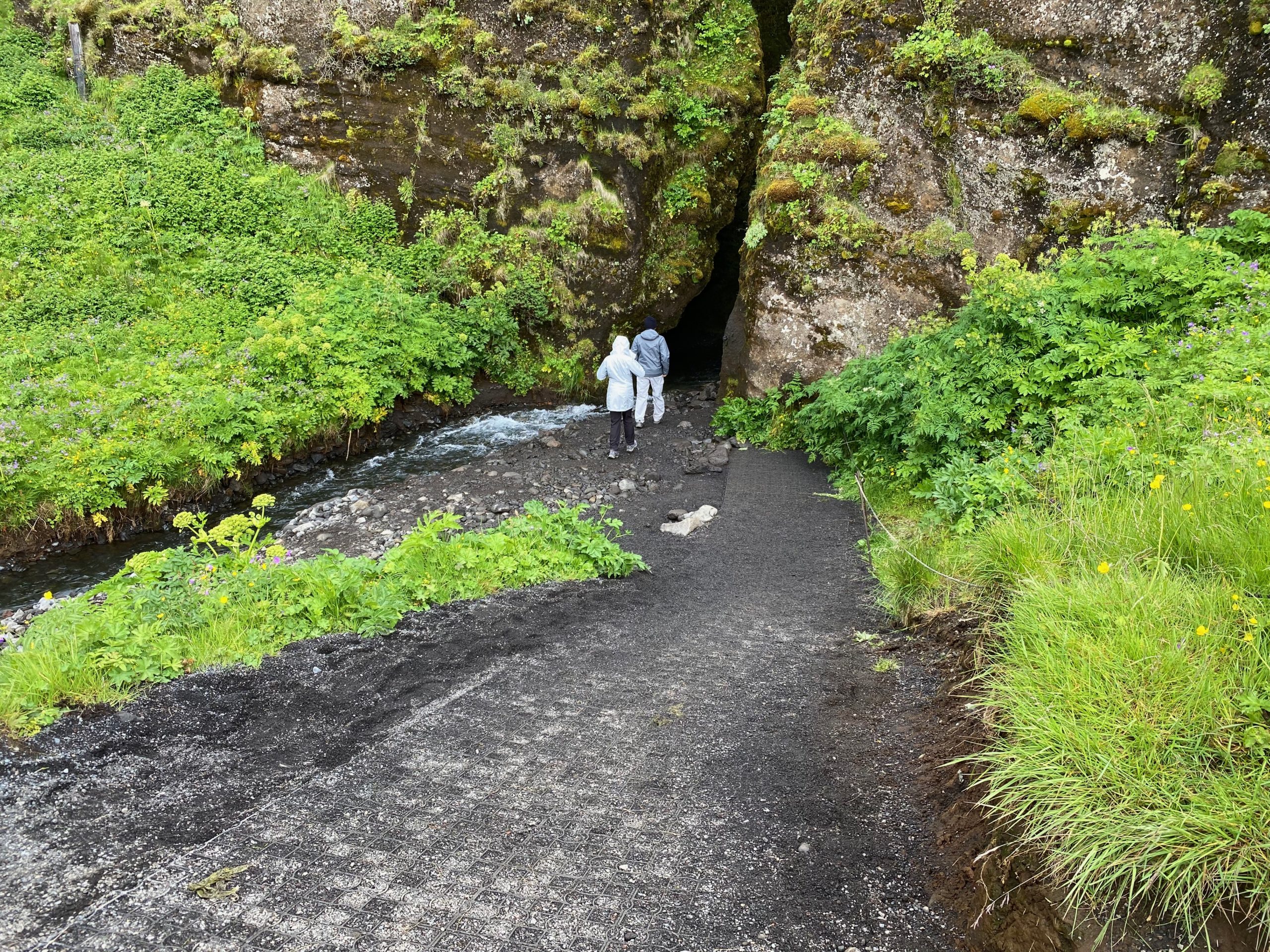 two people walking in a cave