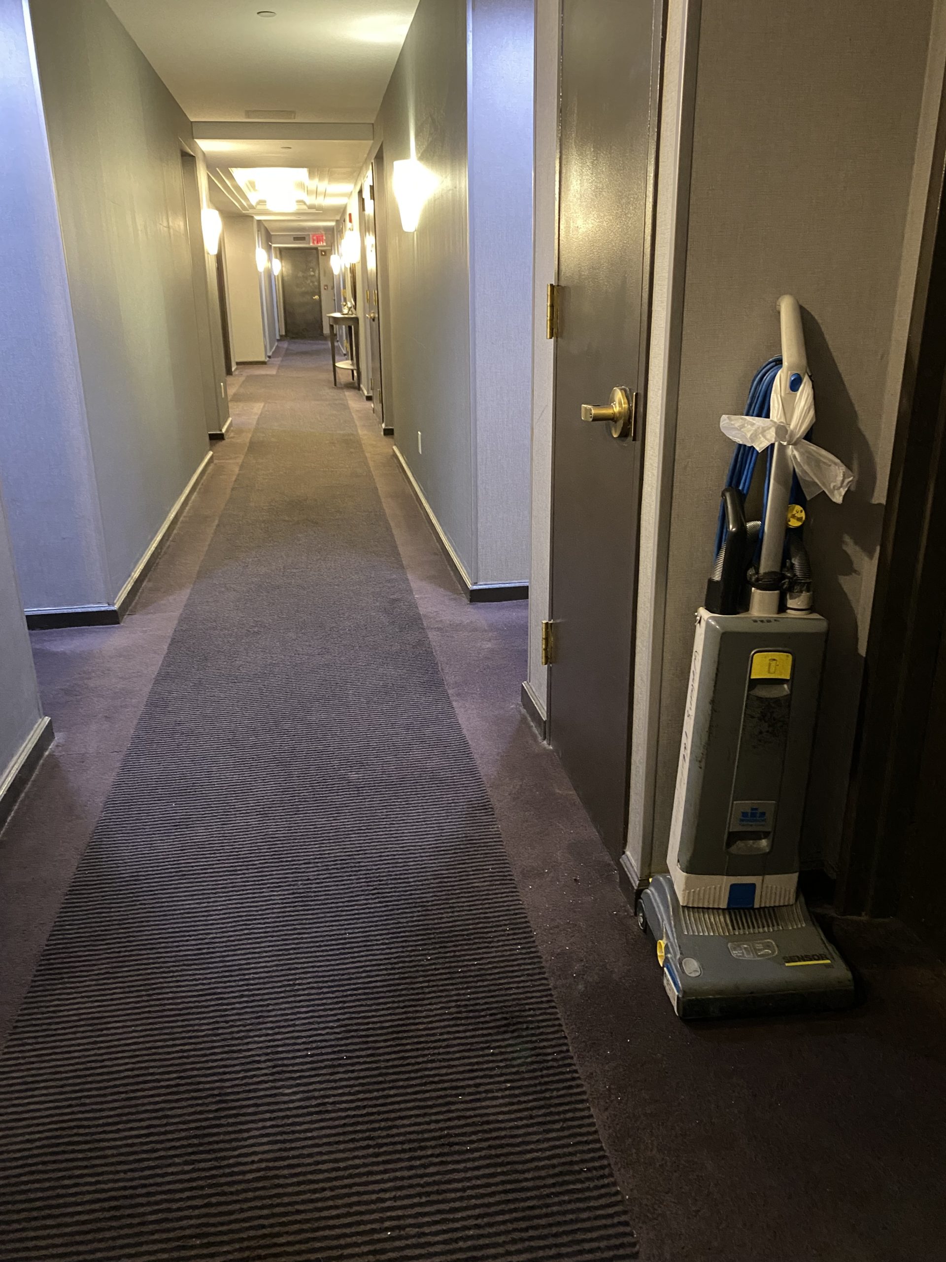 a hallway with a vacuum cleaner