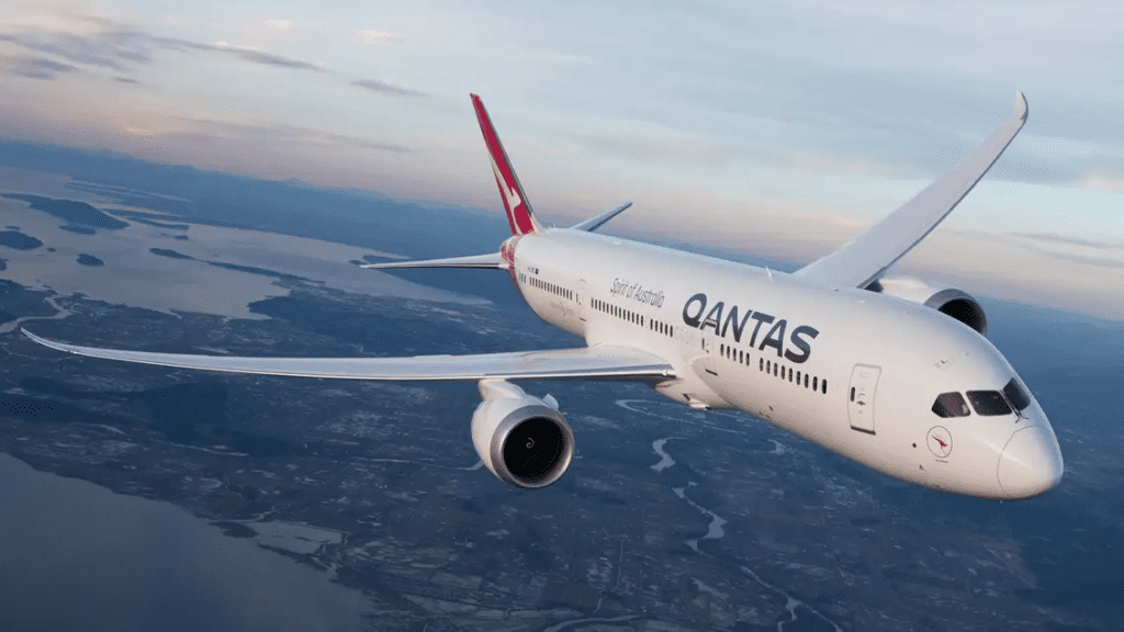 a white airplane flying over land