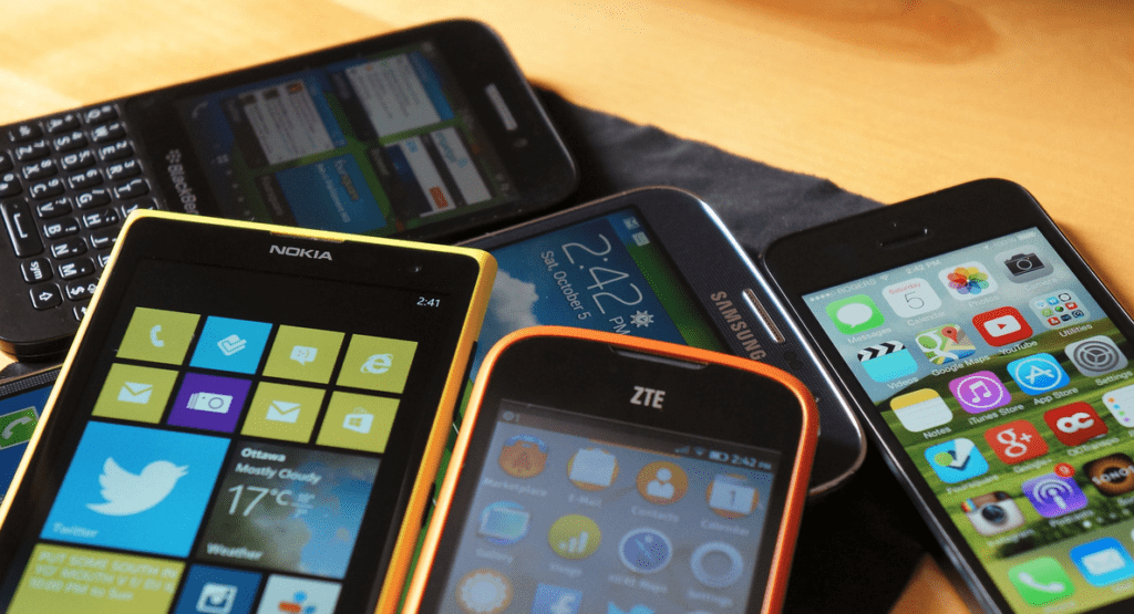 a group of cell phones on a table