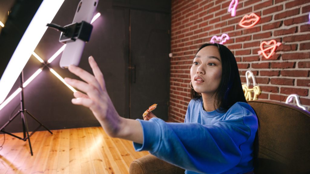 a woman taking a selfie with a phone