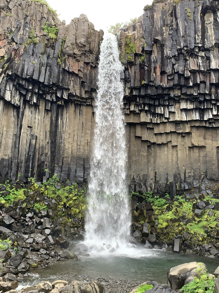 a waterfall over a rock wall