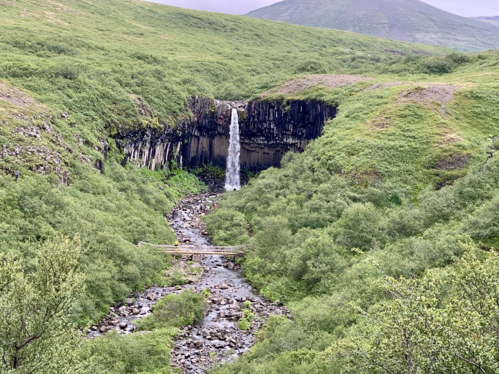 a waterfall in a valley