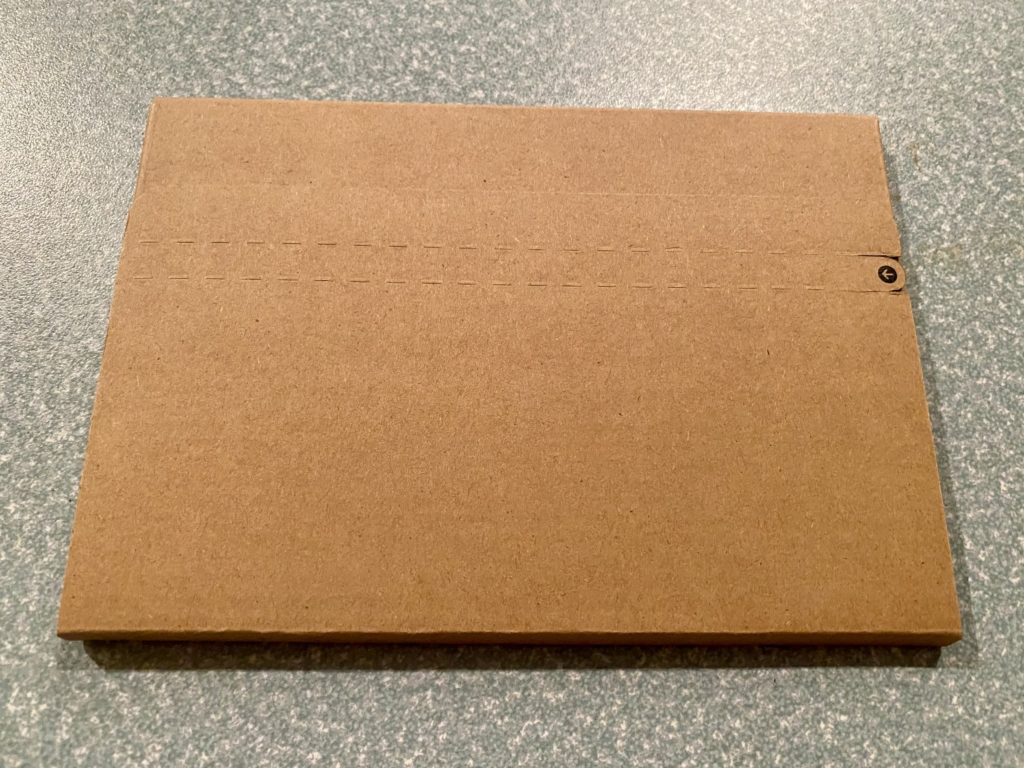 a brown cardboard box on a grey surface