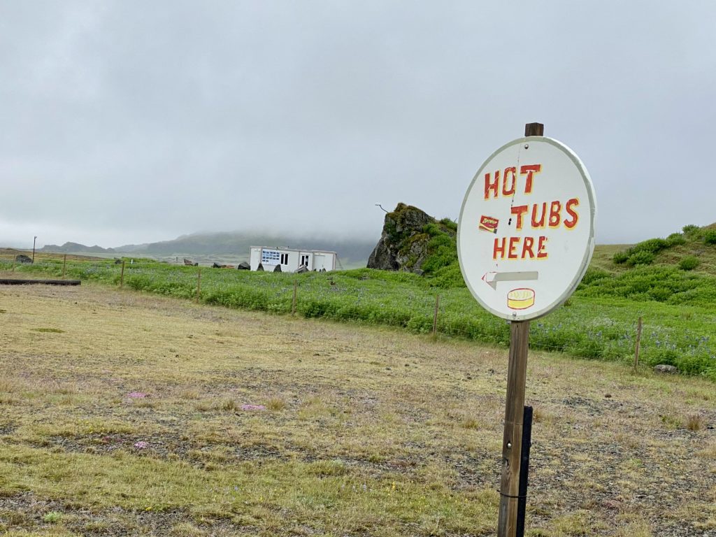 a sign on a pole in a field