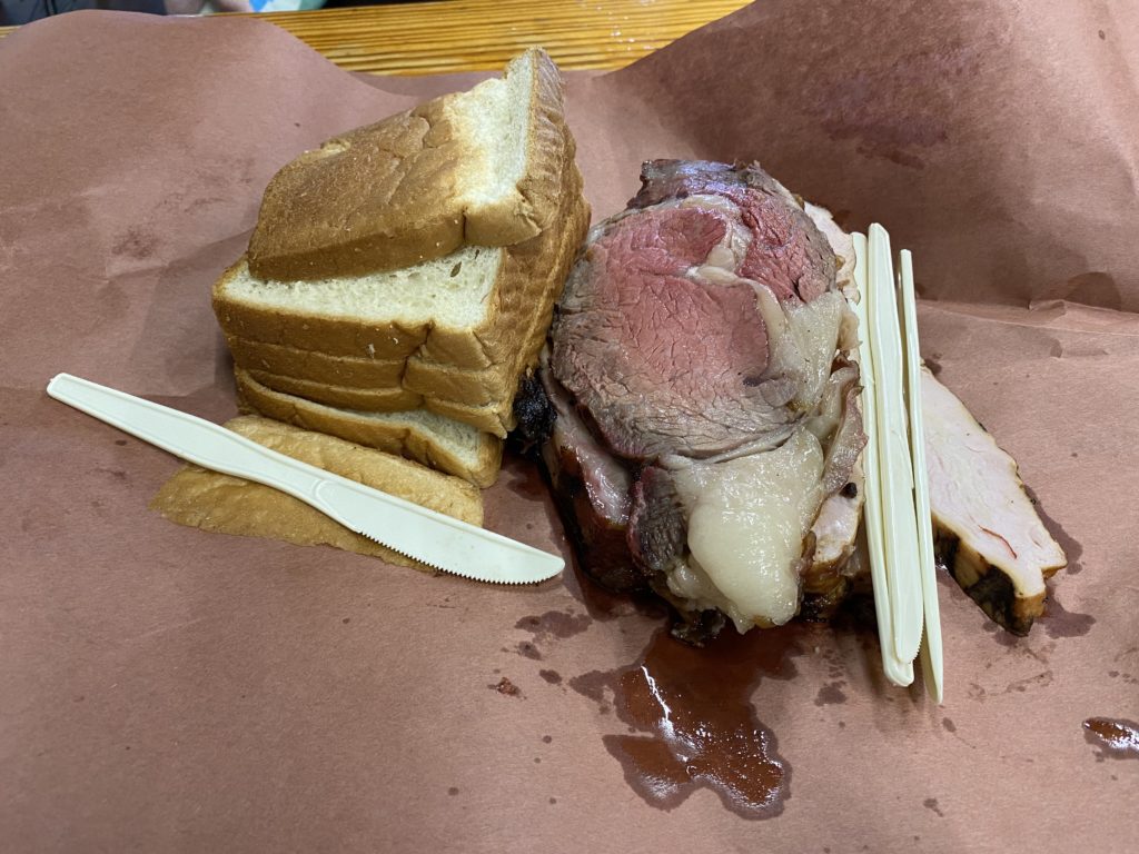 a piece of bread and meat on a brown paper