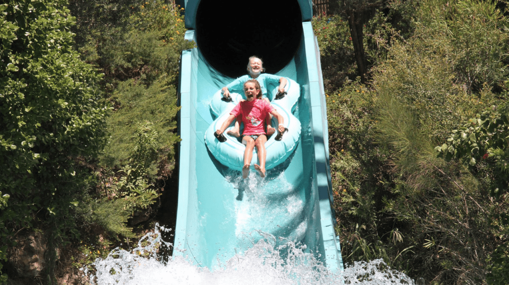 two girls riding a water slide