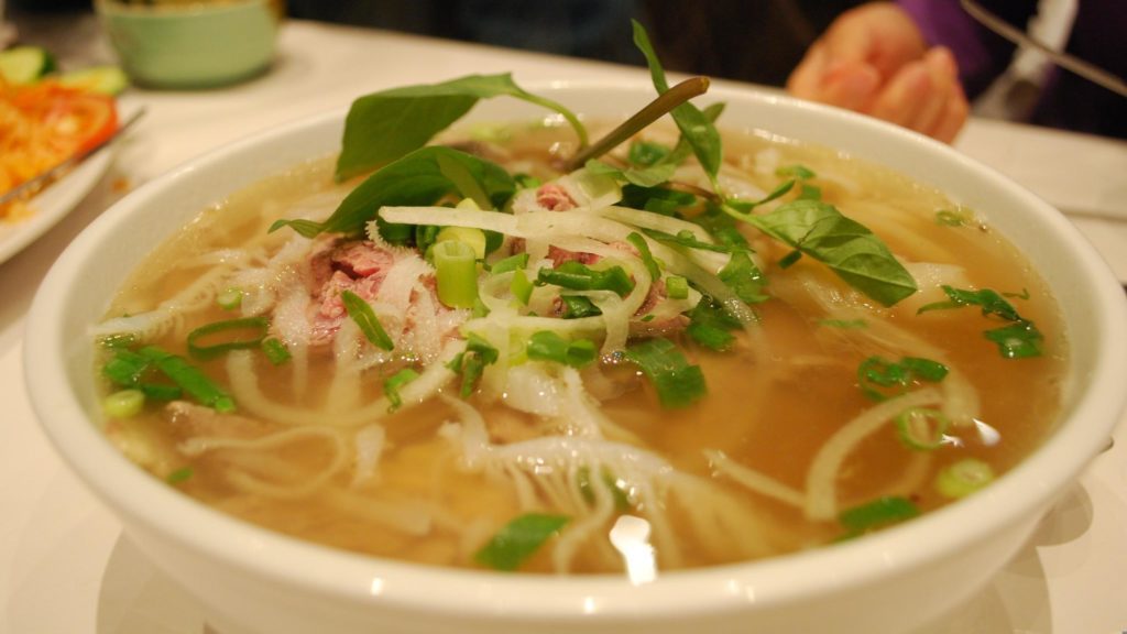 a bowl of soup with vegetables and meat