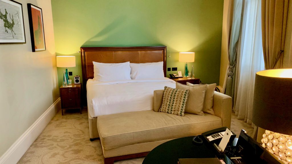 a bed with a couch and a lamp