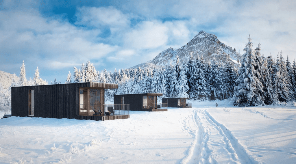 a group of cabins in a snowy area