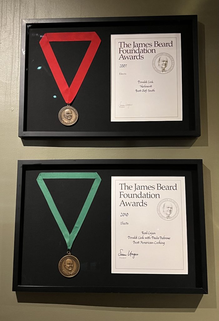 a two framed awards with a medal and certificate