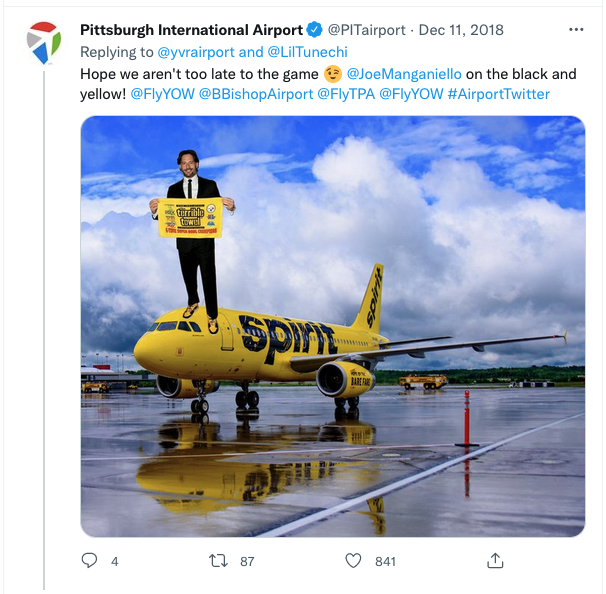 a man holding a sign on top of a plane