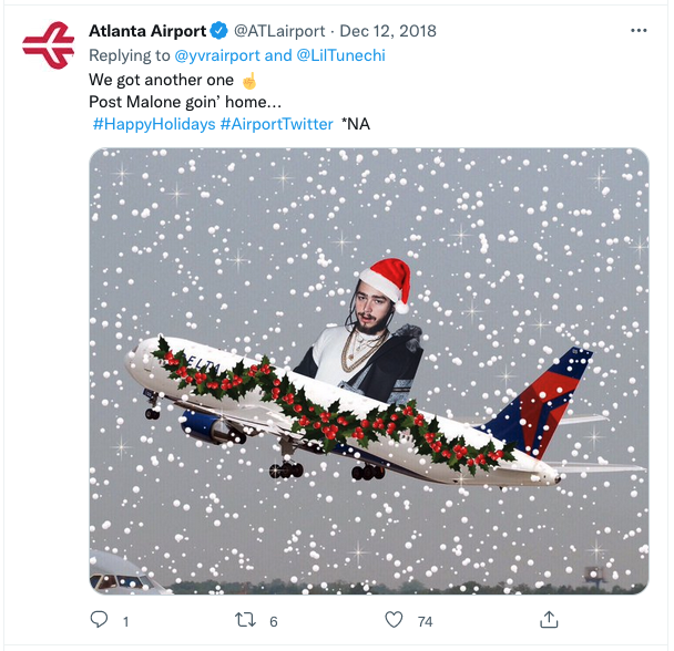 a man in a santa hat flying in the air with a plane decorated with garland