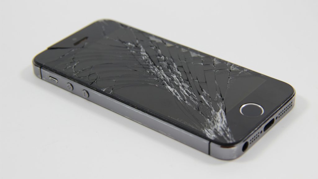 a black cell phone with a cracked screen