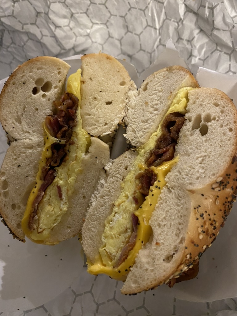 a sandwich with bacon and cheese