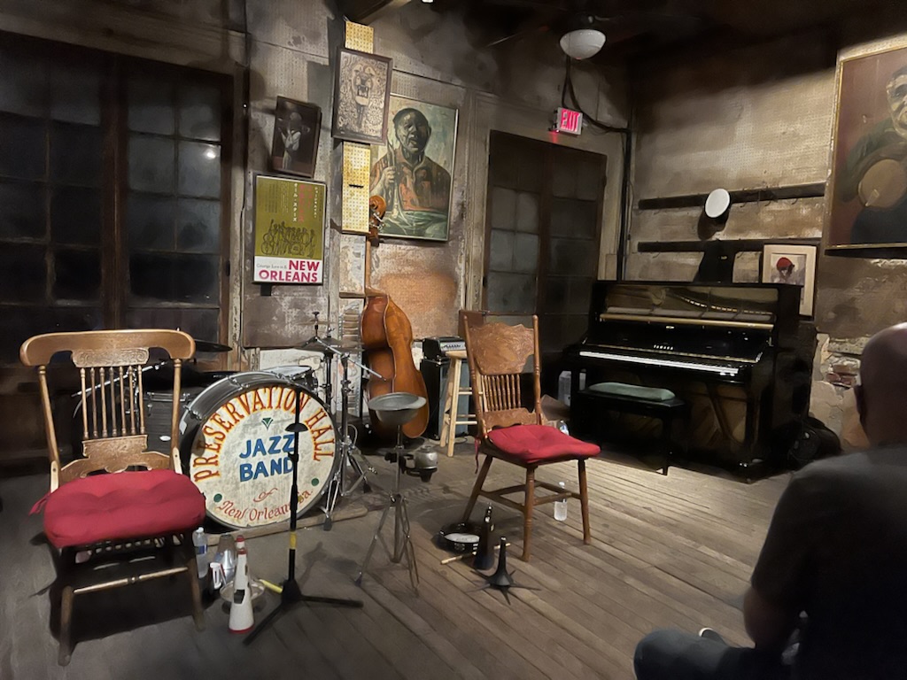 a room with a piano and chairs