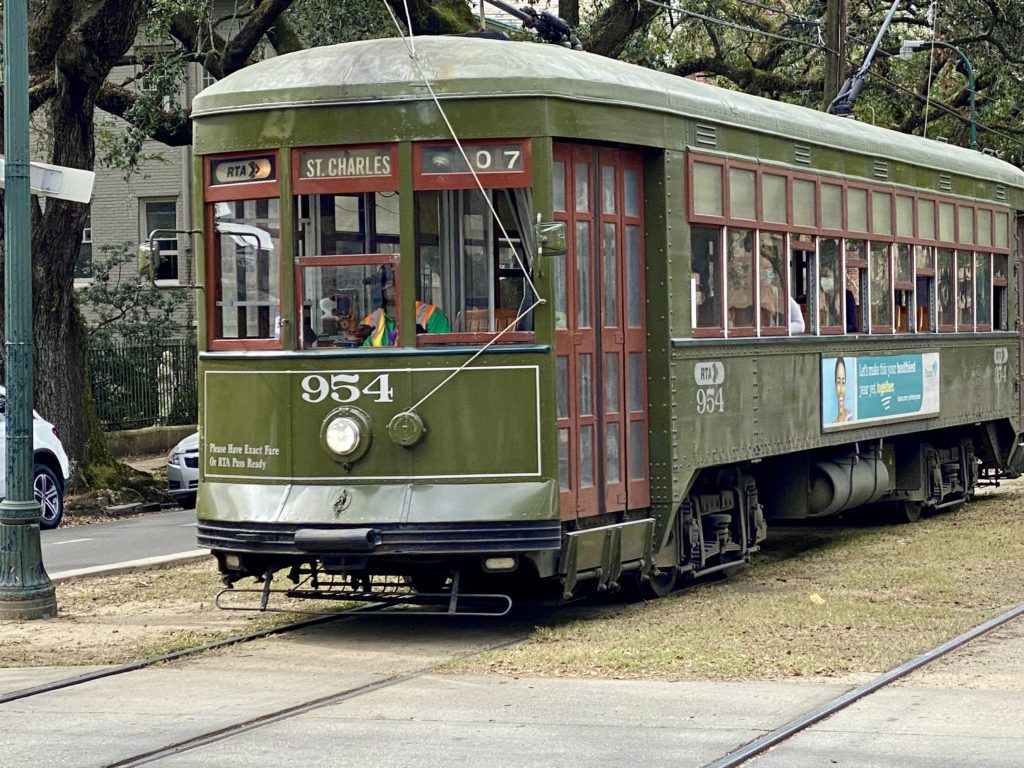 a green trolley on a street