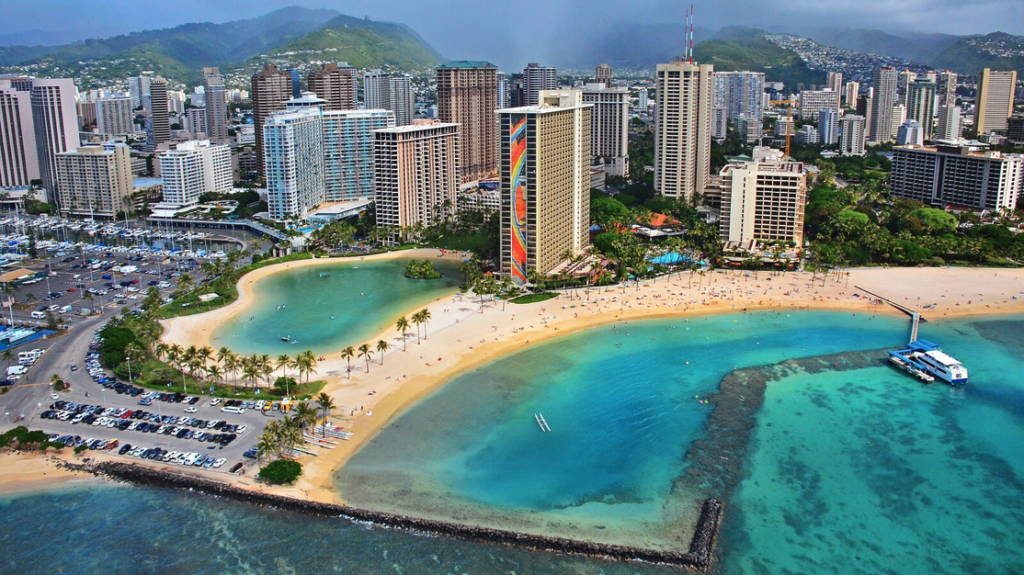 a aerial view of a beach with buildings and a city