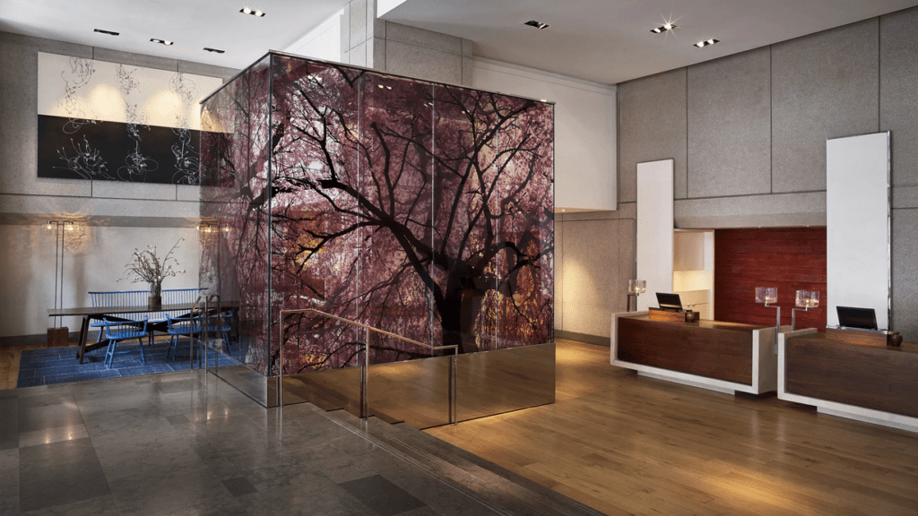 a glass wall with a tree on it