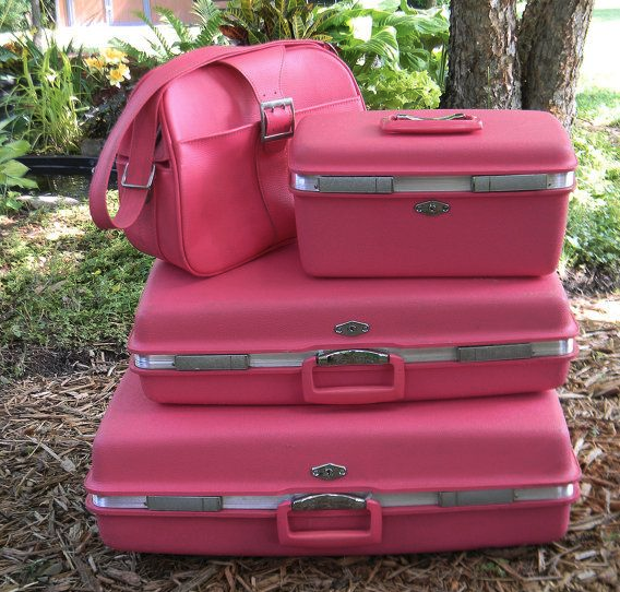 a stack of pink suitcases