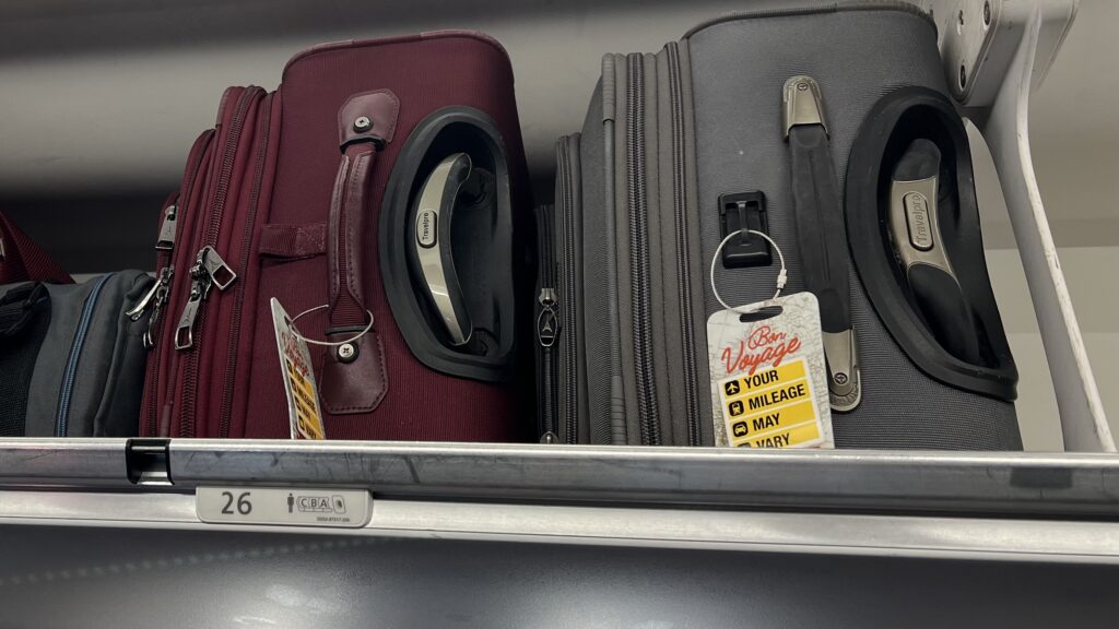 luggage on a shelf with a price tag
