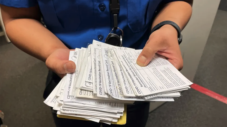 a person holding a stack of medical forms