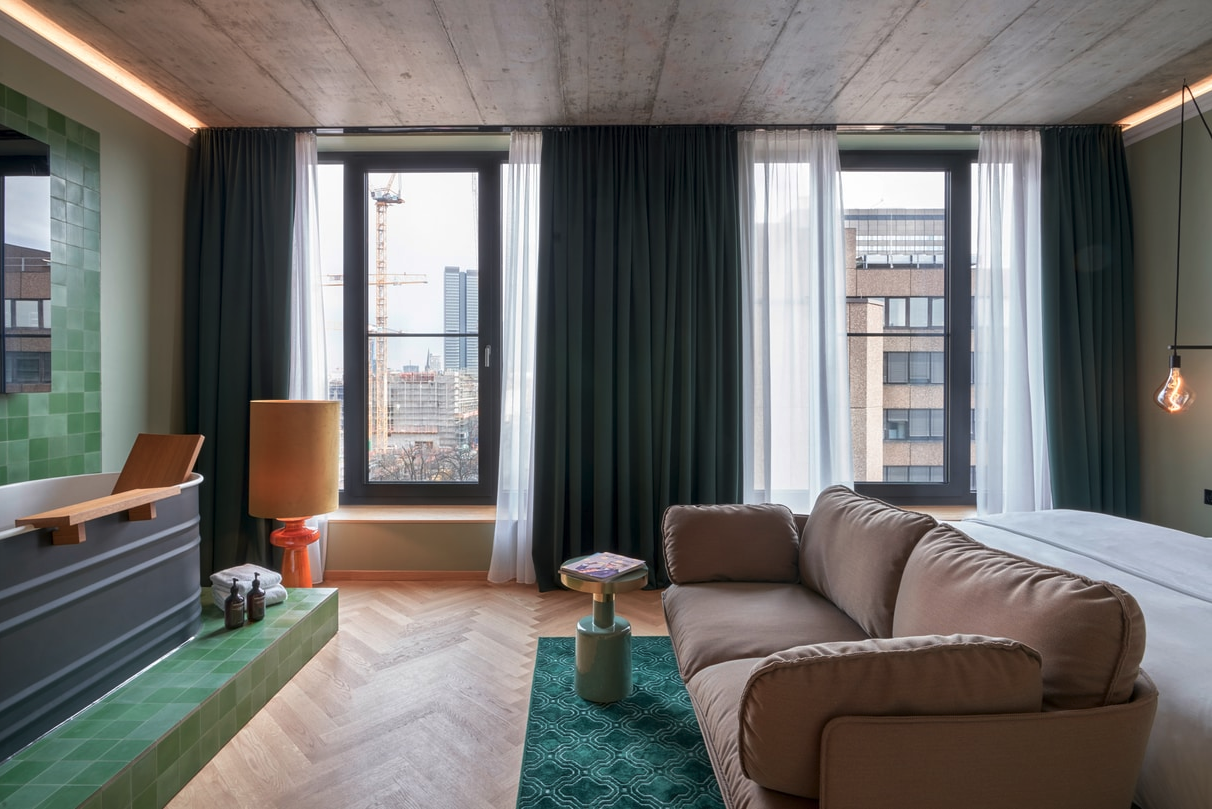 a living room with a couch and green rug