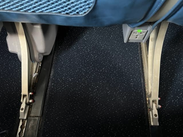 a black carpet with a blue seat and a blue seat