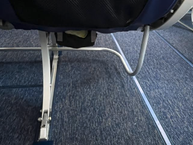 a seat with a metal leg
