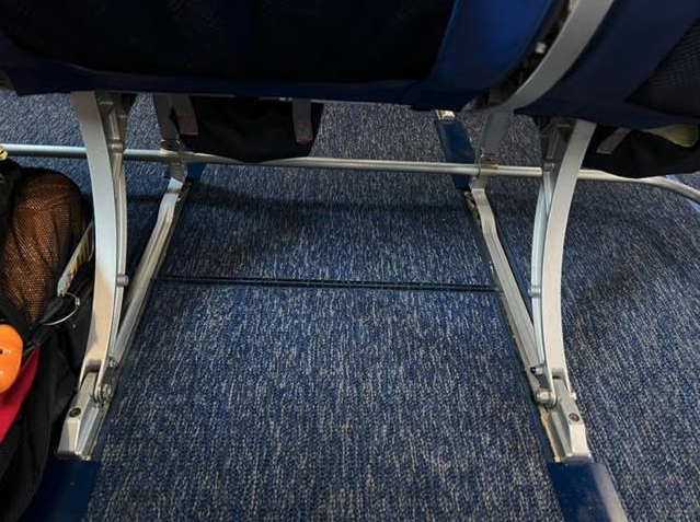 a blue and silver seat with metal legs