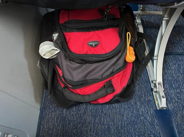 a red and black backpack on a blue carpet