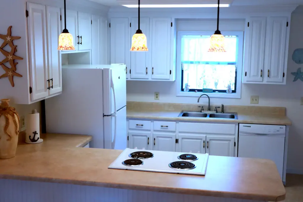 a kitchen with white cabinets and a stove