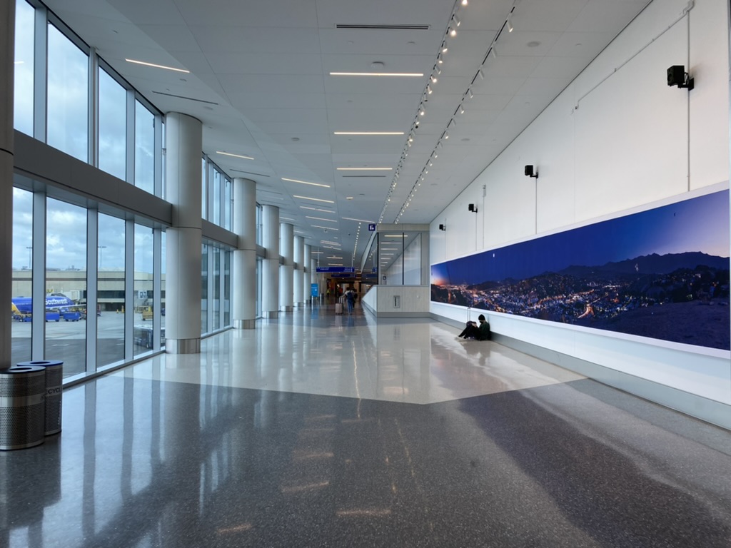 a large hallway with large windows and a large poster on the wall