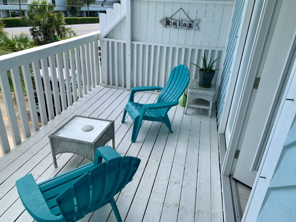 a deck with chairs and a table